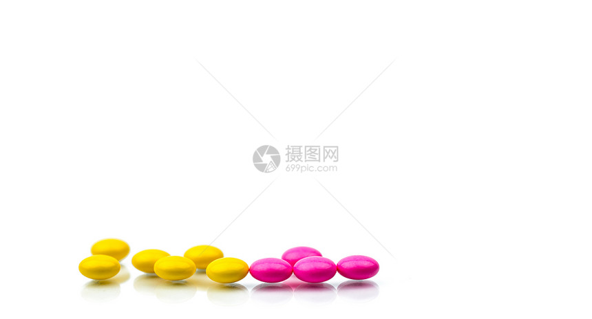 一堆粉红色和黄色的圆形糖衣片丸图片