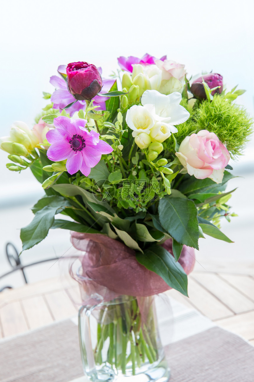 木桌上花瓶里的牡丹玫瑰海葵白色小苍兰的大美丽粉红色花束春图片