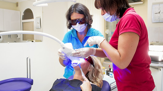 牙科医生使用特殊的紫外光灯用于图片