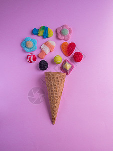 粉红色背景中带果冻糖的冰淇淋蛋筒图片