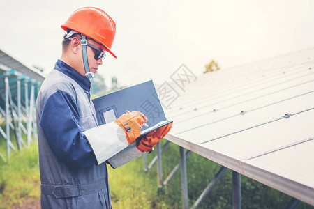工程师操作和检查太阳能屋顶太阳能发电厂的发电量背景