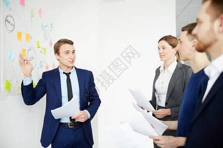 自信的经理或雇主站在白板旁图片