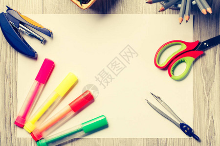 灰色木板上的彩色毡笔订书机指南针剪刀和铅笔图片