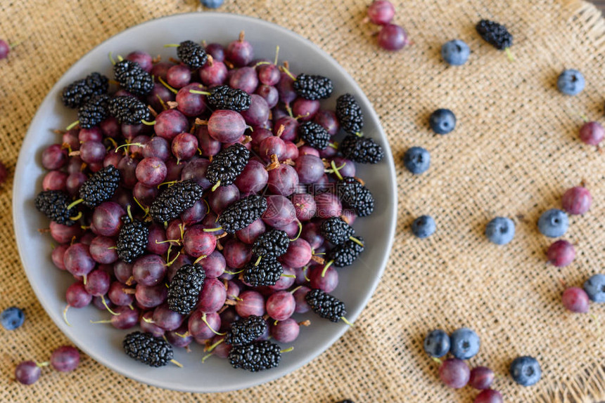 蓝莓黑莓和醋栗的新鲜浆果在盘子上它图片