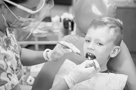 一个小男孩在牙科诊所的牙医招待会上儿童牙科儿童牙科黑白复古风格摄影口图片