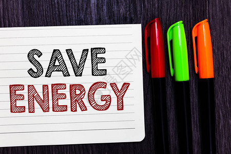 文字书写文本节省能源减少使用电量以实现类似结果的商业概念笔记本纸彩色标记木制背景图片