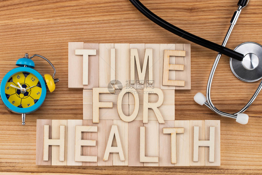 健康时间在有听诊器和闹钟的木块上用旧字图片