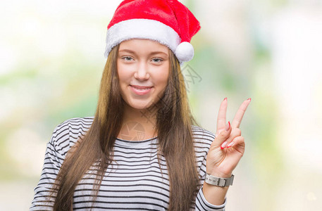 年轻美丽的caucasian女子穿着圣诞帽图片