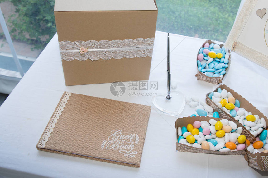新婚夫妇的婚礼桌与糖衣杏仁和留言簿图片