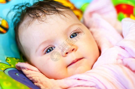 可爱和健康的微笑温和快乐积极新生婴儿白种人女婴与深蓝的眼睛健康图片