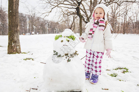 孩子在冬日在公园里堆雪人图片