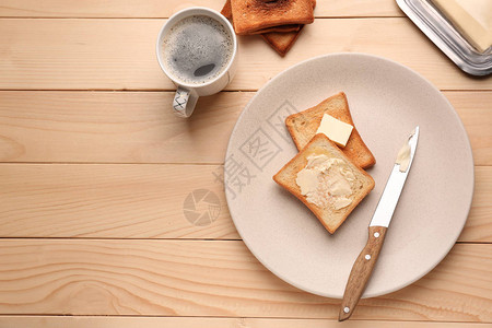 美味烤面包加黄油和木制桌图片