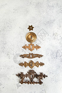 古老的古董铜质钥匙孔盖子以圣诞树的形状排成一列紧贴在图片