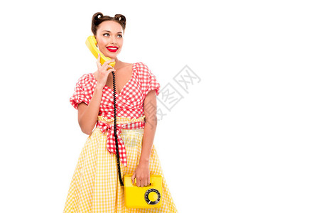 用老式黄色电话交谈的时尚女孩图片