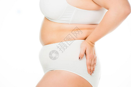 超重妇女用手拍着与白隔绝的臀部图片