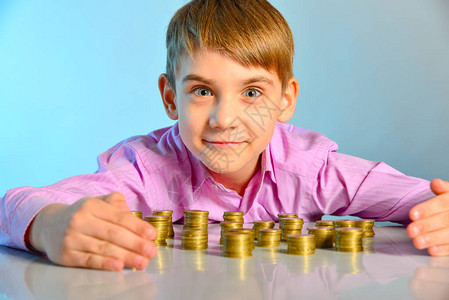 快乐的男孩守卫着他的现金储蓄儿童商图片