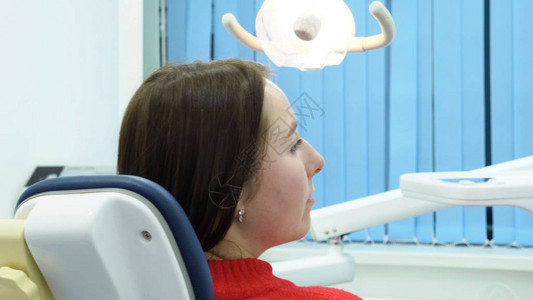 女牙医与病人交谈媒体牙医妇女在开始工作前咨询病人关图片