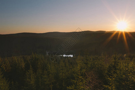 森林山谷的美丽日落小池塘和阳光图片