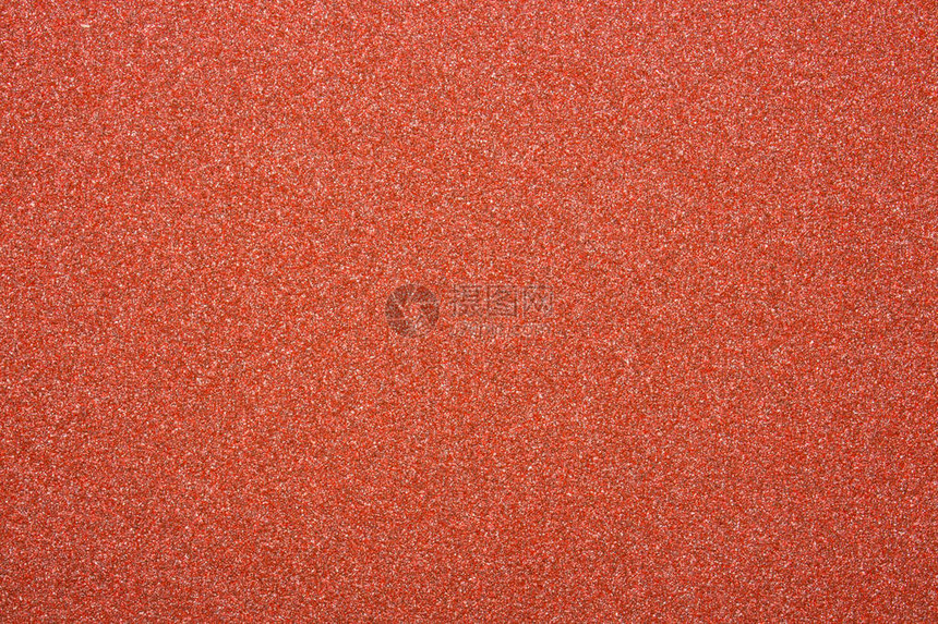 红色砂纸的质地粗糙的砂纸背景图片