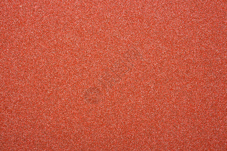 红色砂纸的质地粗糙的砂纸背景背景图片