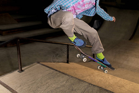 在极端公园玩滑冰特技翻滚滑板的无法辨认的年轻人的行动镜头图片
