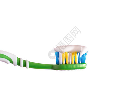 牙刷挤在牙刷膏白色背景上图片