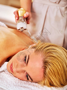 美容院的妇女接受电动疗法刺激身体治疗图片