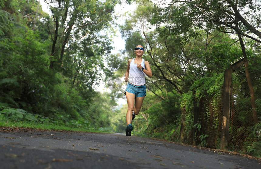 女跑者在夏季公园小径上奔跑健康身妇图片