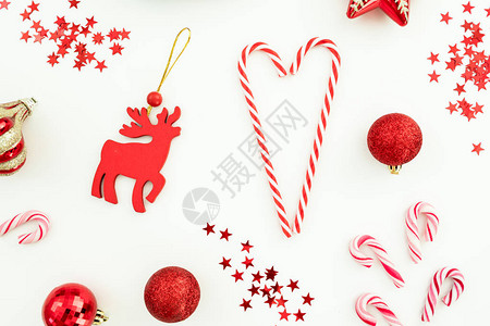 圣诞或新年模式红色玩具糖果甘蔗和白底面的彩蛋平躺着图片