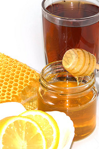 蜂蜜在蜂窝的背景上蜂蜜在玻图片