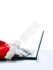 圣诞老人在白色背景上使用笔记本电脑圣诞老人戴着白手套图片