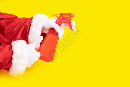 圣诞老人拿着黄色背面的红色撒布机圣诞老人手上有清图片