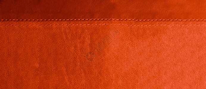 红色和橙色皮革背景底部有红色缝线图片