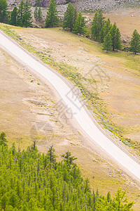 穿过山丘和森林的荒泥道路自然在山图片