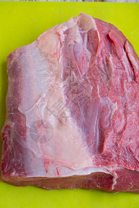 新鲜的生猪肉和牛肉一块新鲜的红肉一大块新鲜的肉躺在砧板上一图片