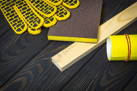 用于打磨木板的工作手套和黄砂纸图片