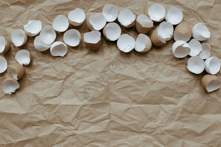 米色背景中的蛋壳分离的鸡蛋图片