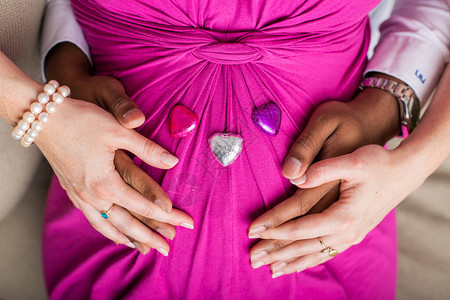 怀孕的夫妇爱上了婴儿的肚子手放在肚子上的婴儿肿块上图片