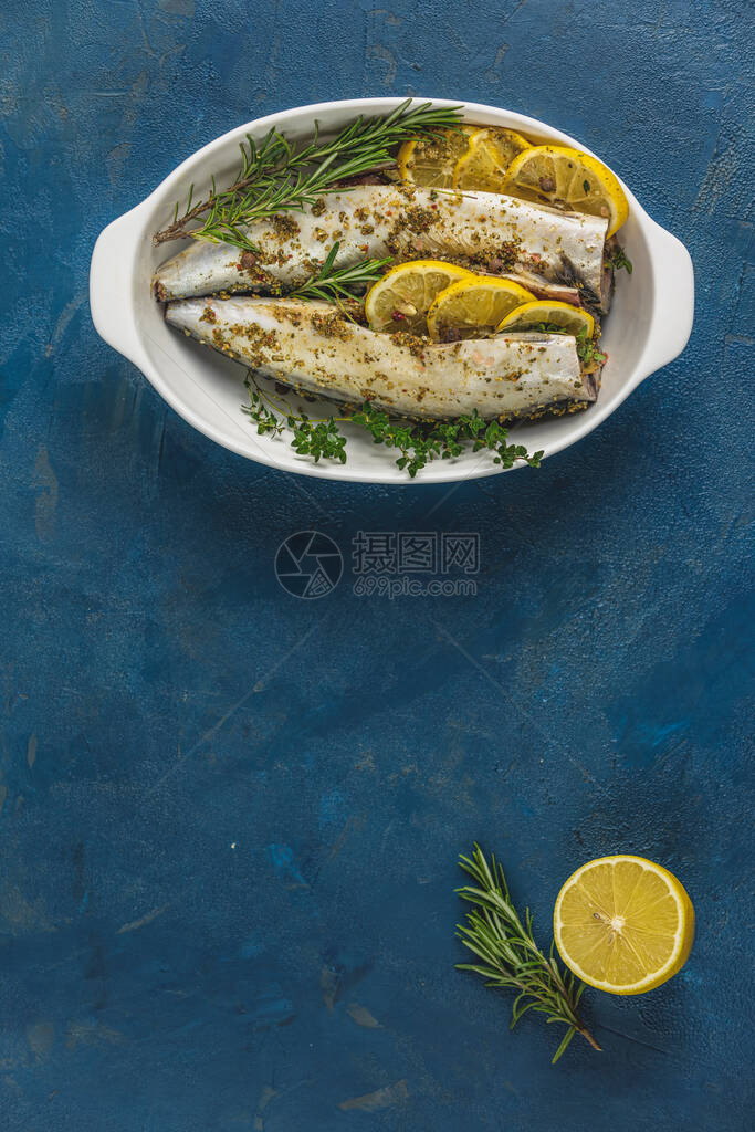 玉米饼用柠檬百香迷迭香和料在白盘上供应经典蓝色表面有生的鲑鱼海产食品平板背景为您提供图片