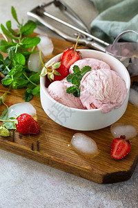自制有机草莓冰淇淋草莓冰淇淋球和薄荷叶轻石或板背景图片