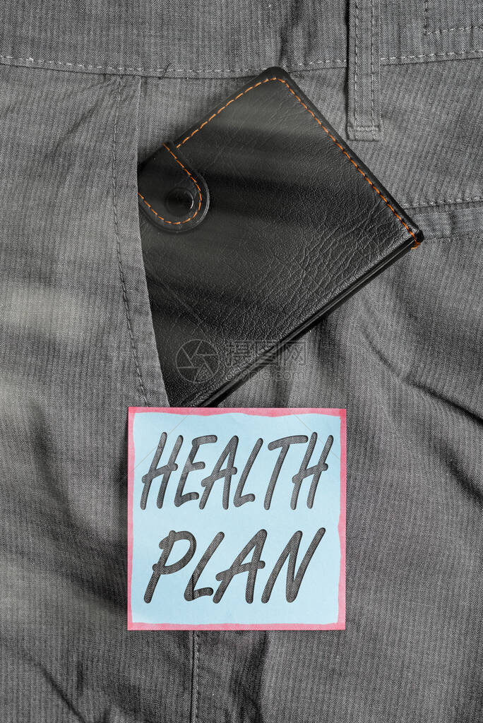 显示健康计划的书写笔记涵盖高成本医疗服务的保险类型的商业概念靠近符号纸的裤子前图片
