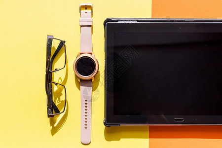 平板笔记本智能电话手腕表和计算机鼠标等女工作空间均匀图片