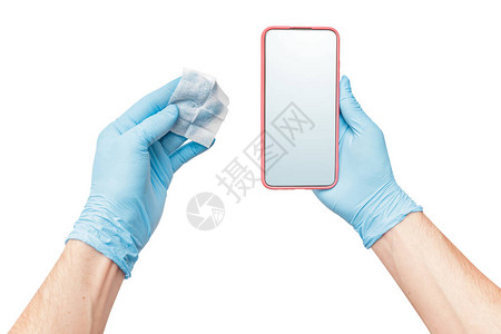 一个戴着医用防护手套的人用消毒剂擦拭手机图片