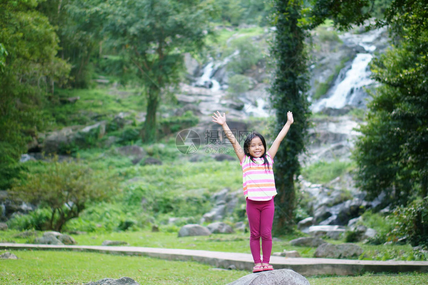 亚洲儿童可爱或小女孩快乐地举起手图片