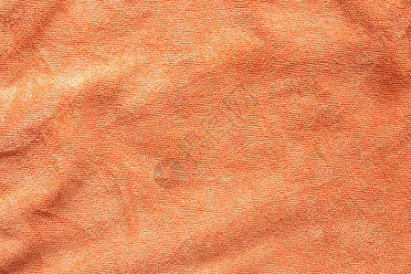 橙色毛巾织物纹理表面特写背景图片