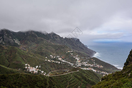 绿色草地陡坡的美丽宁静景色山坡上的美丽的村庄特纳里夫Ten图片