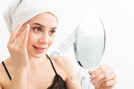 千百年女在洗完澡后按摩脸照镜子自由空图片