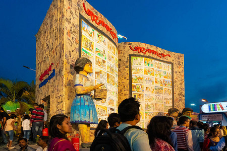 一个女孩的大雕塑和她的书籍在加尔各答书展上出背景图片