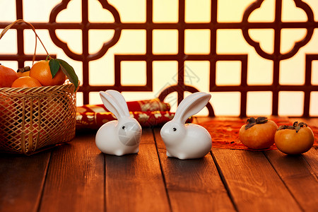 坐着吃柿子的兔子喜庆兔年新年静物摆件背景