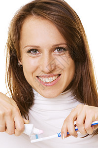 有牙膏和牙刷的笑脸女人在白色图片